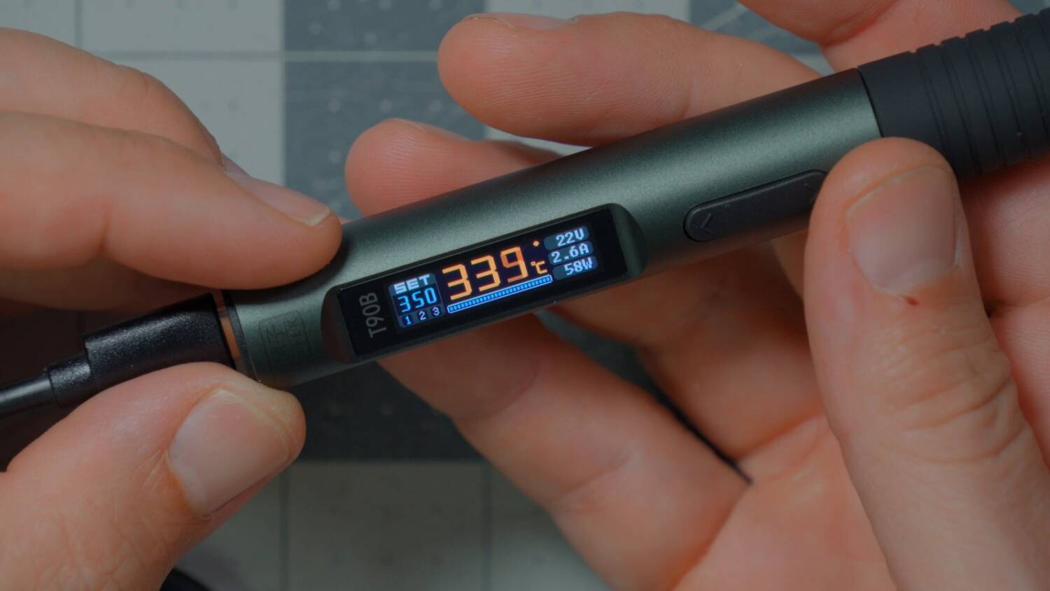 The T90B's color display showing temperature, voltage, current and watts