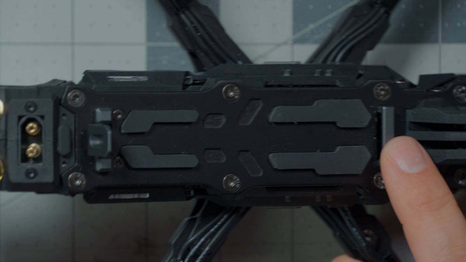 The metal piece at the front of the battery mount