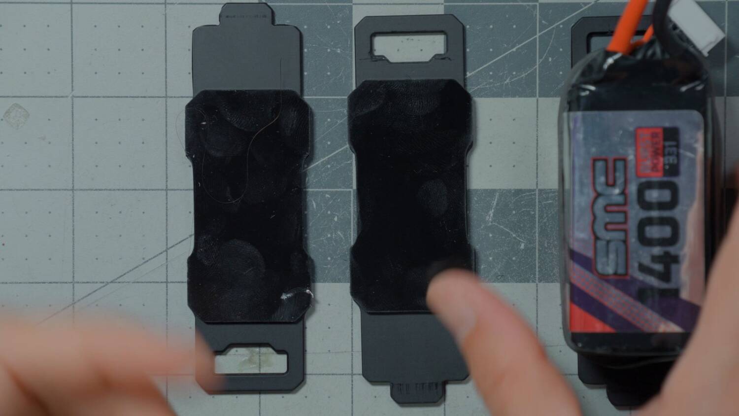 The three battery trays with sticky pads