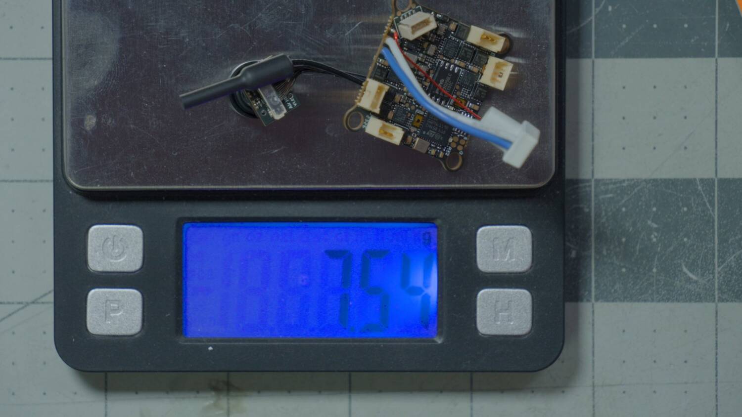 The flight controller and camera on the scale