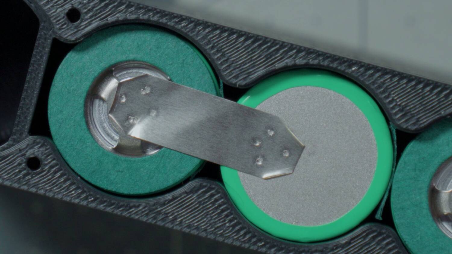 Nickel strips spot welded across pairs of cells