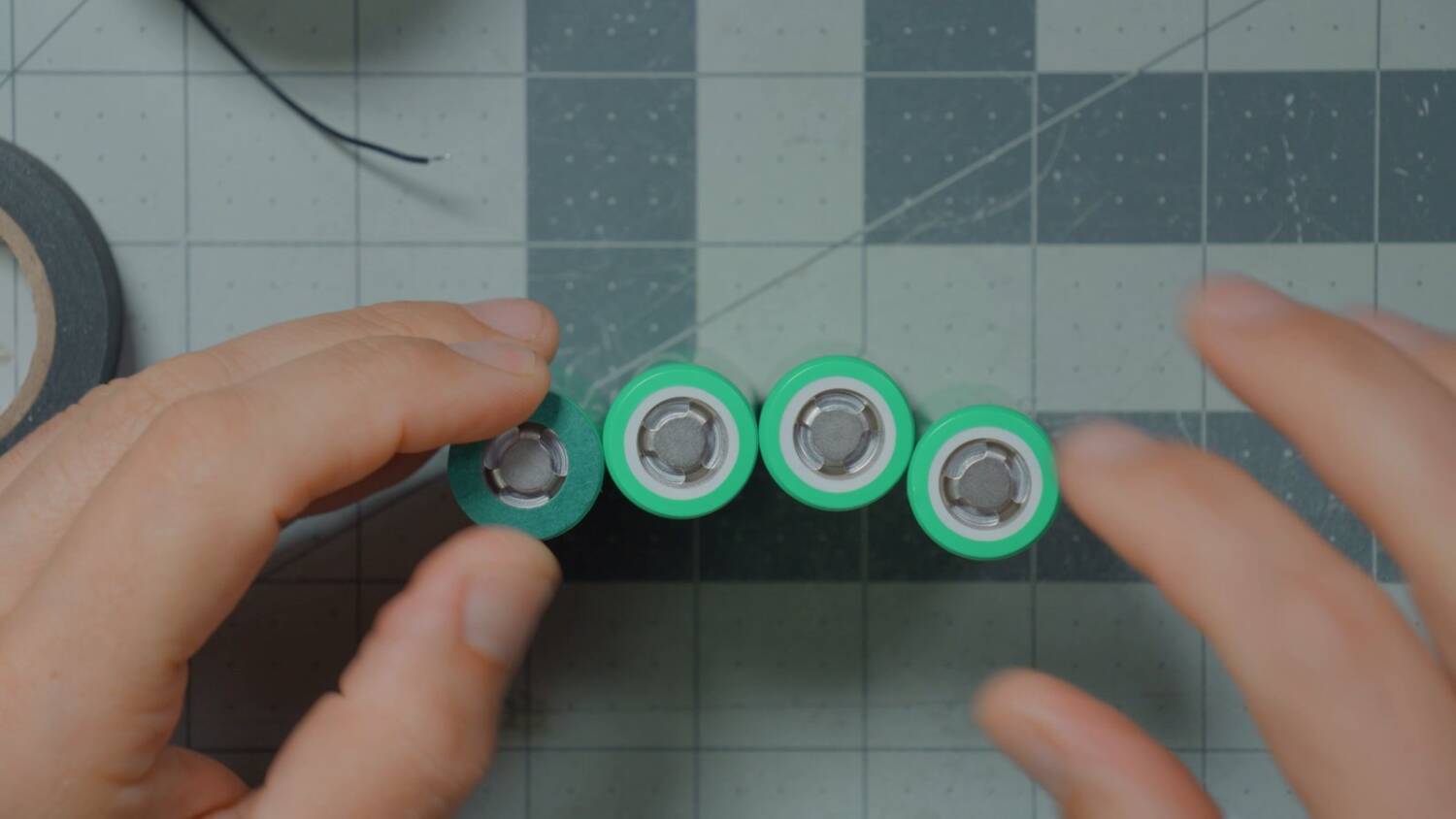 The positive ends of the cells, with the can's rim around each terminal