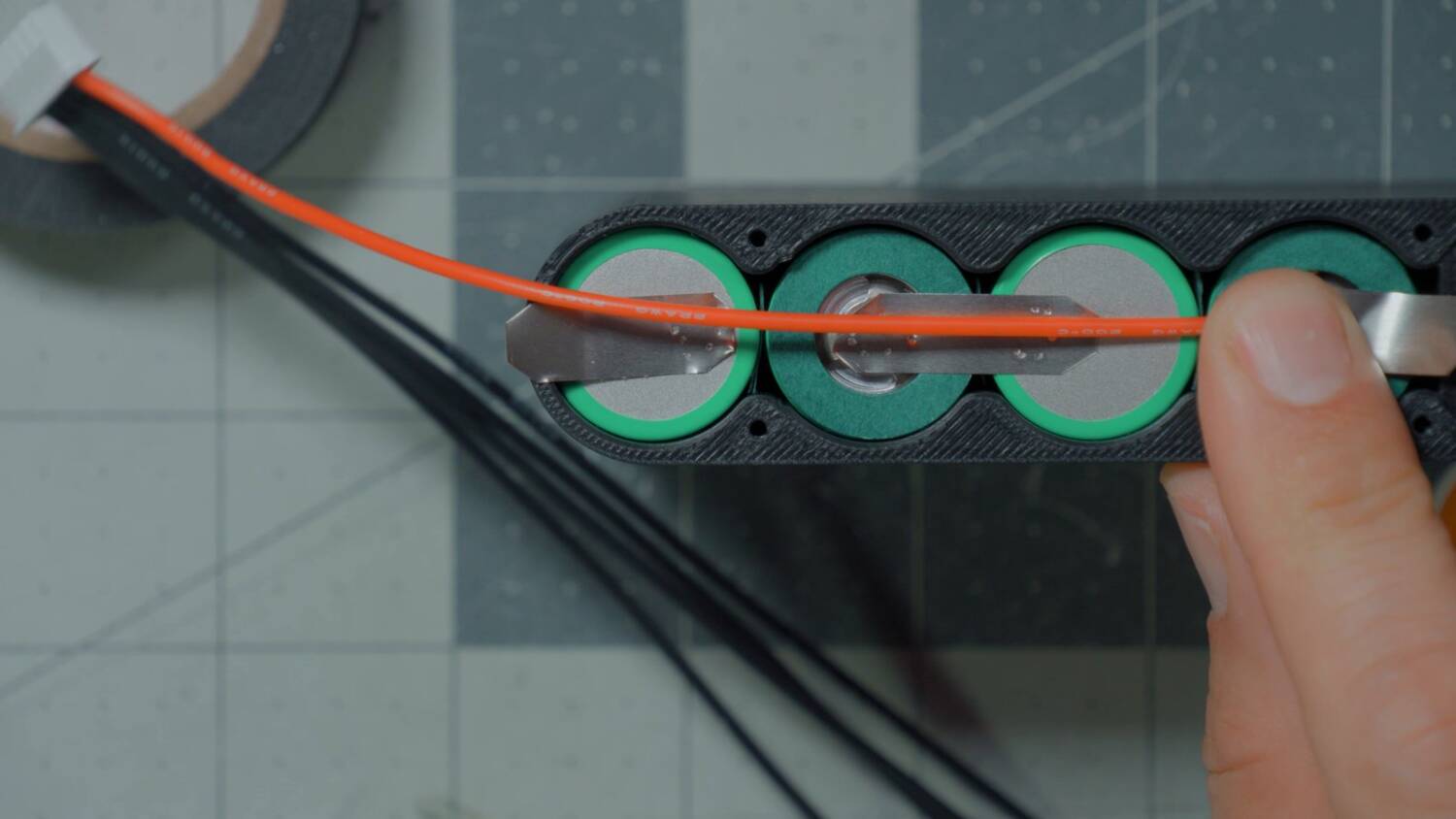 Red wire laid along the cells to measure its length