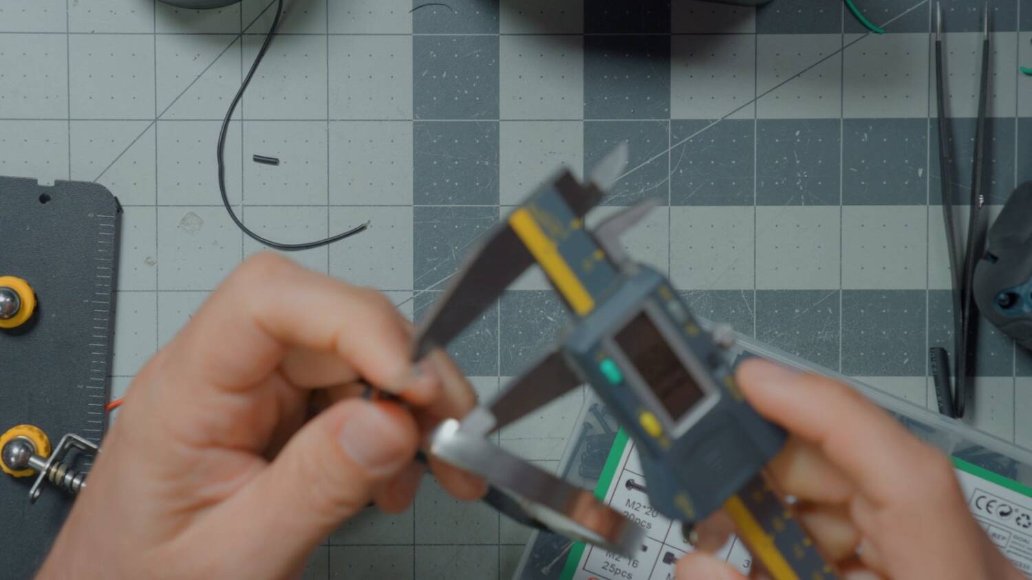 Measuring the 0.10mm nickel strip with calipers
