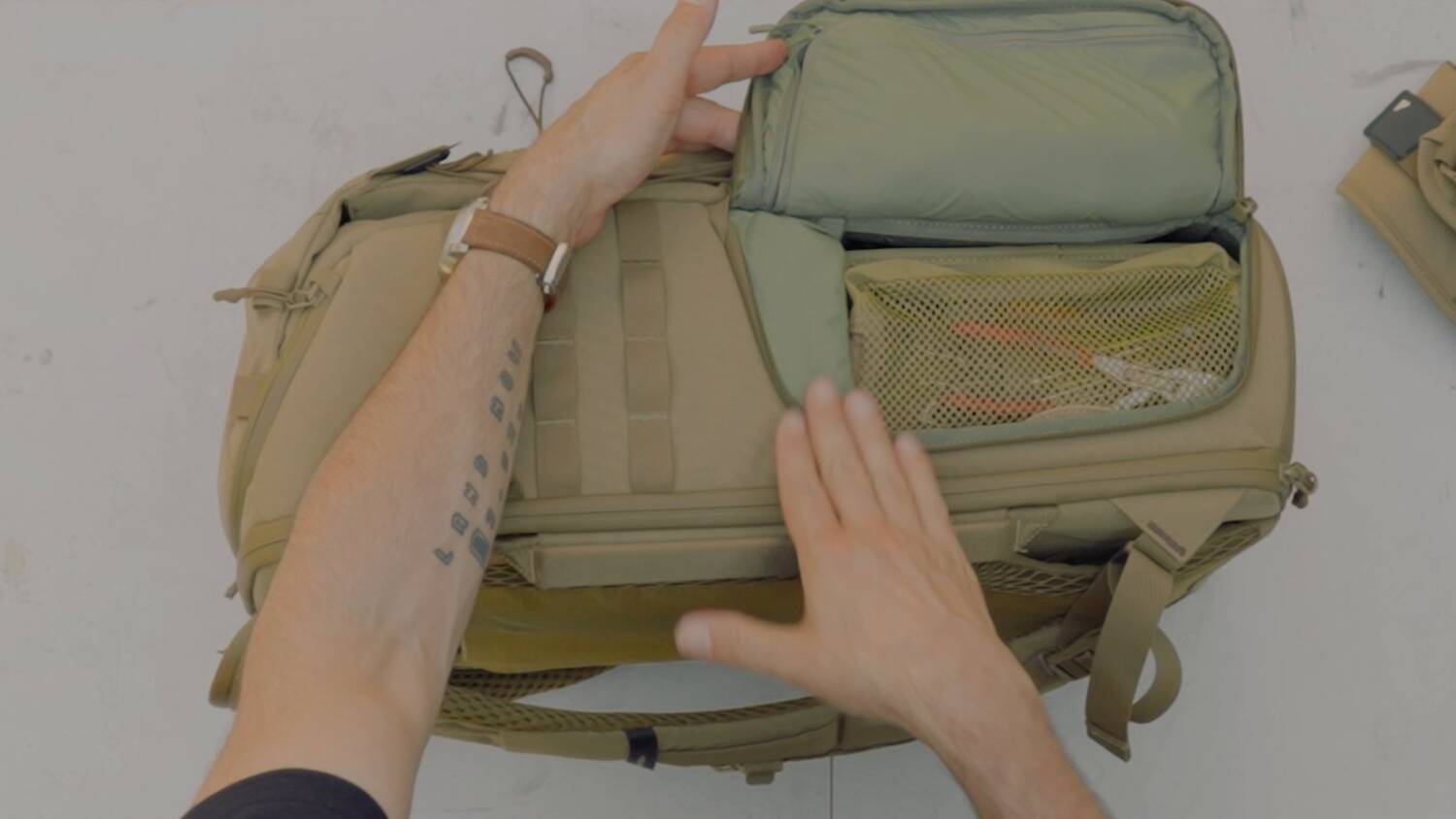 The side pocket that opens into the main compartment